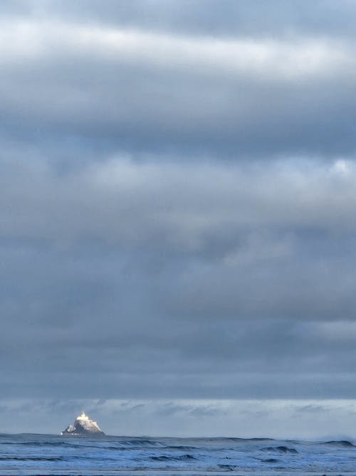 Cloudscape and a Lighthouse on the Sea