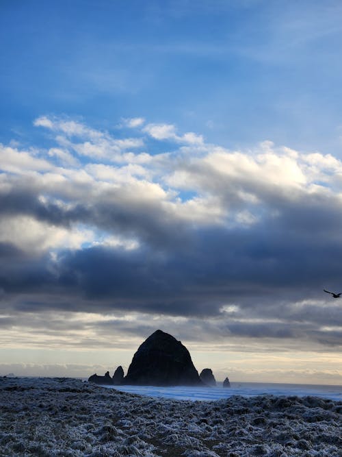 Seascape with the Haystack Rock, and Clouds in the Blue Sky