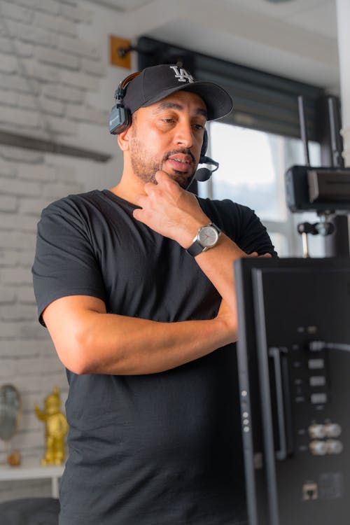 Free Man in Headphones and Baseball Cap Stock Photo