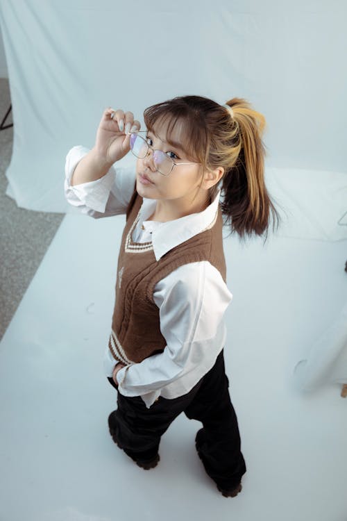 High Angle View of Model Wearing a White Shirt and a Brown Vest