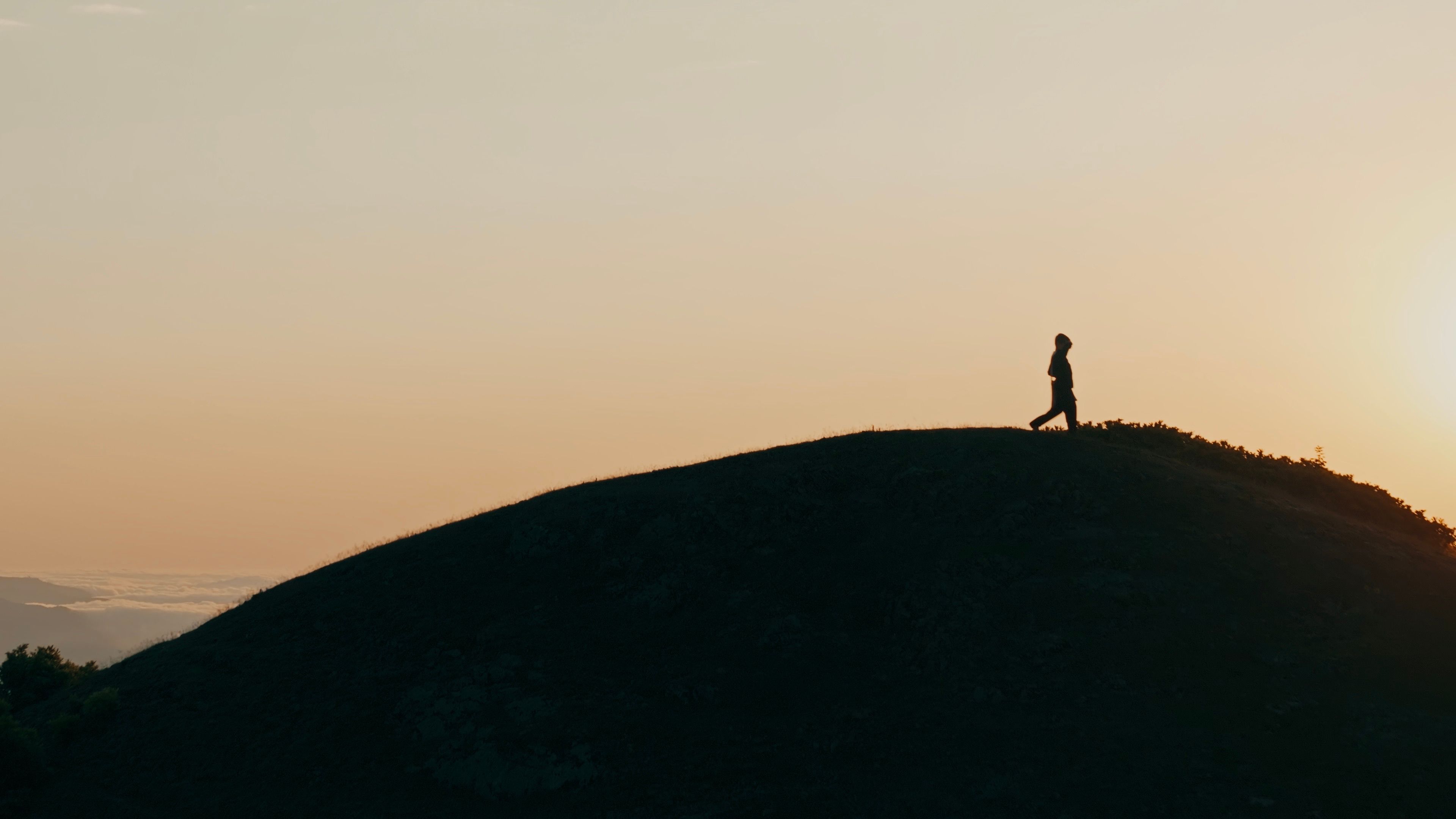 Lone figure on empty granite path, warm low light