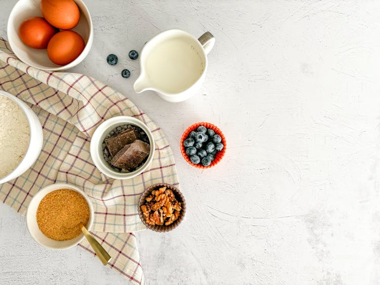 Top View Of Cake Ingredients Standing On White Surface