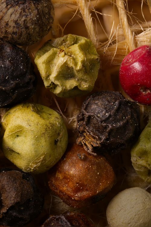 Free Close-up of colorful dried herbs and seeds on a textured background, showcasing natural textures. Stock Photo