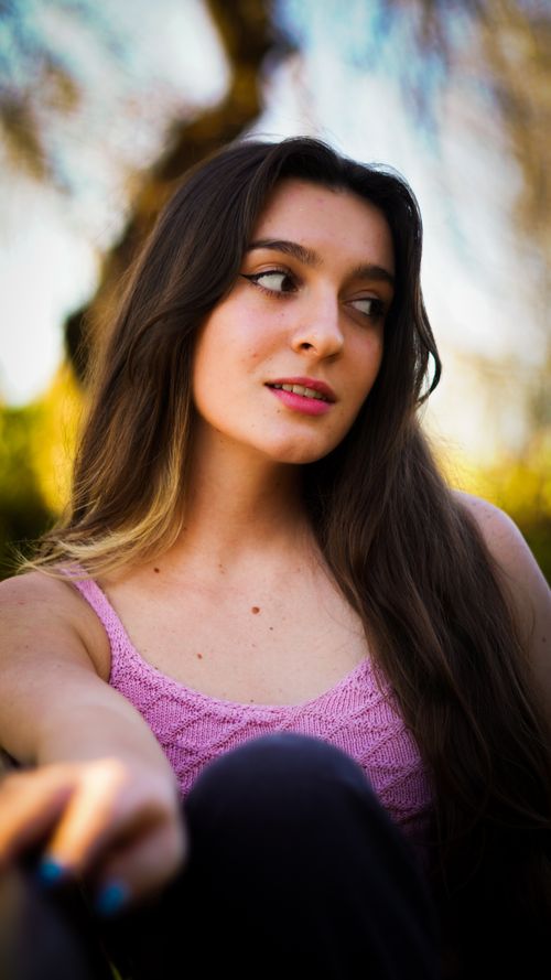 Free A serene portrait of a young woman relaxing outdoors in Leiria, Portugal. Stock Photo