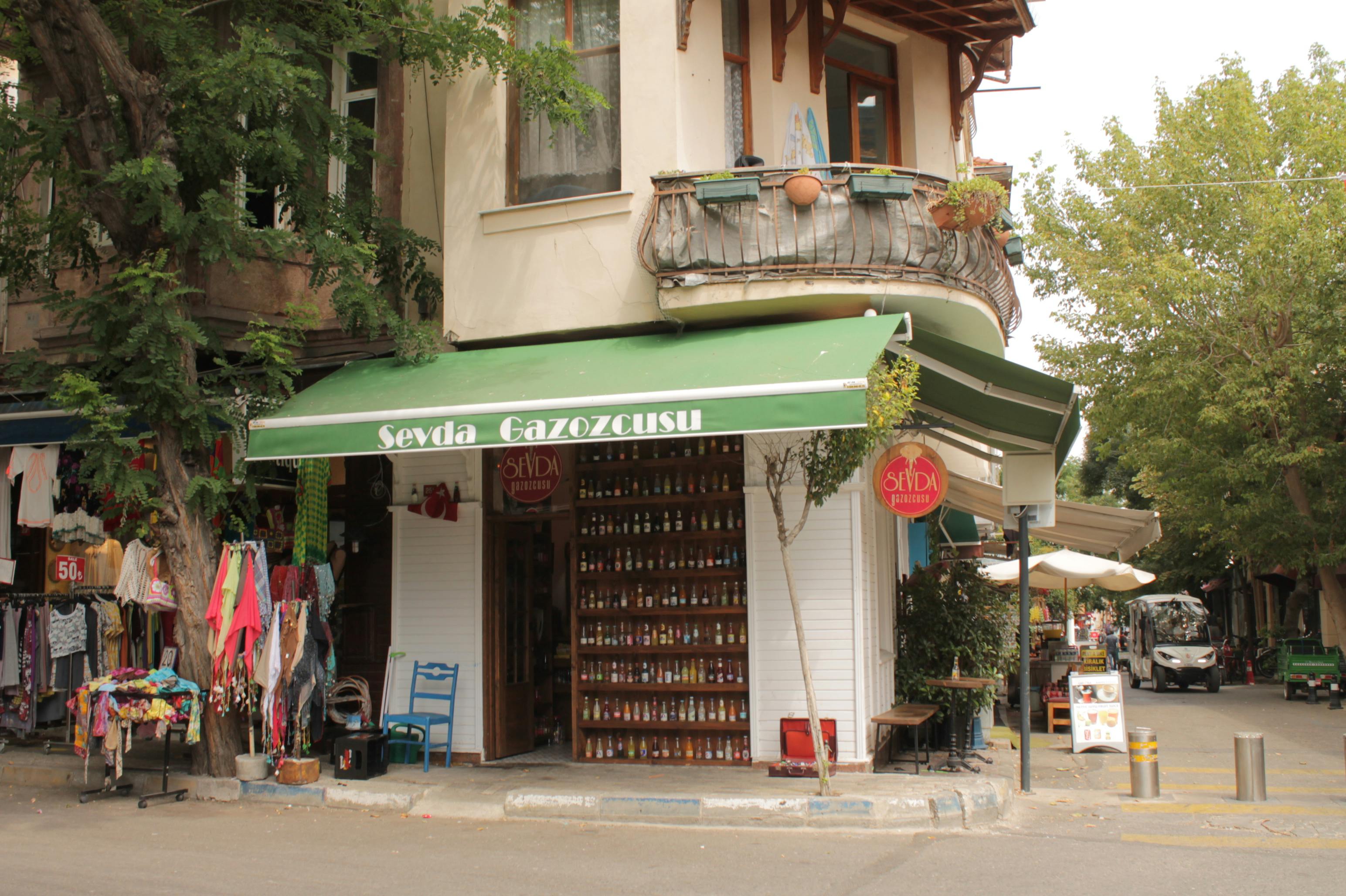 Cozy corner shop in Istanbul showcasing colorful textiles and lush greenery.