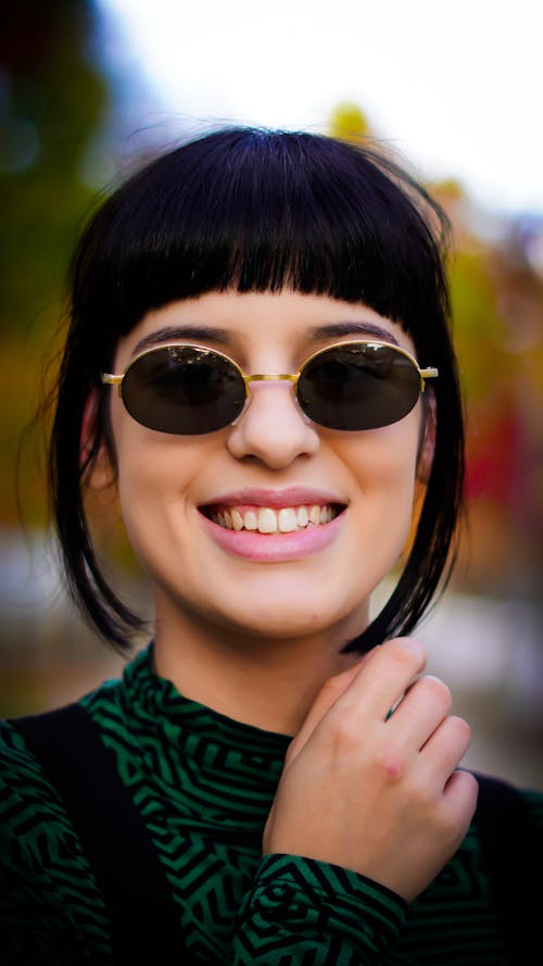 Portrait of a Young Woman with Bangs Wearing Sunglasses 
