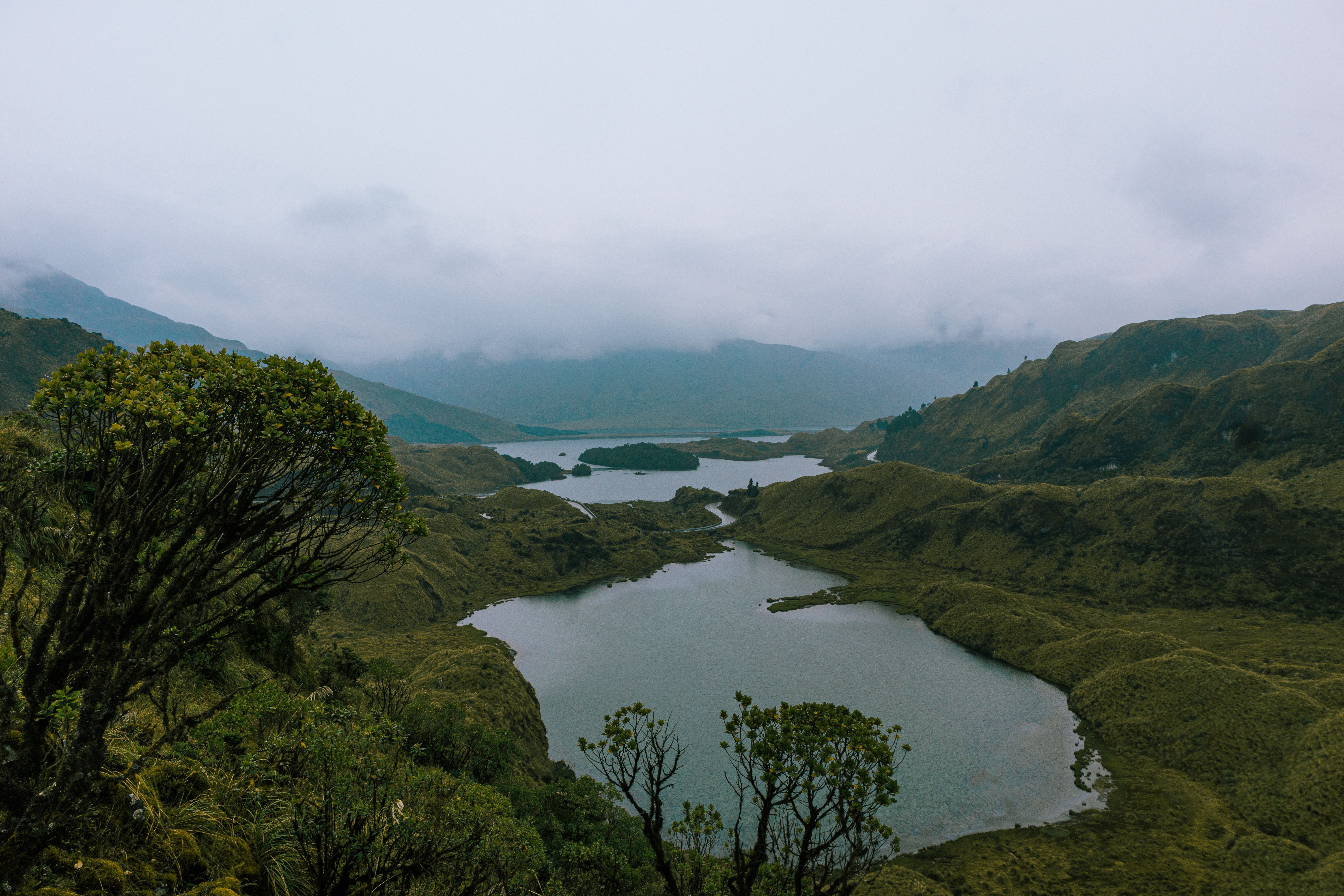 Unbeatable Middle of the World Tour and Hummingbird Reserve Review: Standing Where the Planet Divides Review 2026 - Scenic landscape of Atillo Lagoons in Ecuador surrounded by lush mountains under cloudy skies.