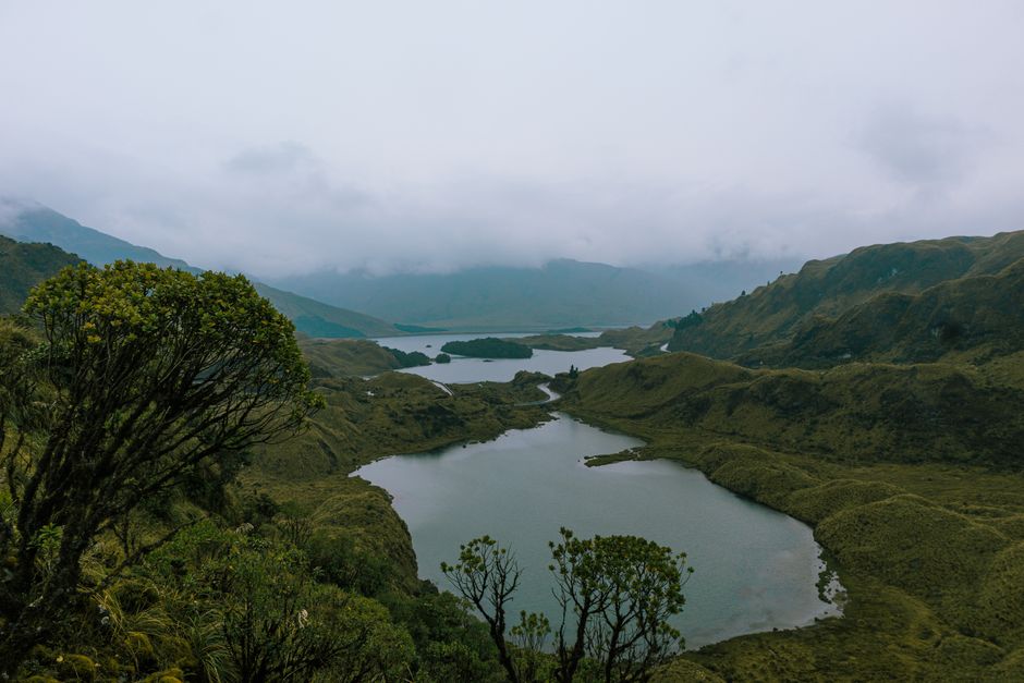 Unbeatable Middle of the World Tour and Hummingbird Reserve Review: Standing Where the Planet Divides Review 2026 - Scenic landscape of Atillo Lagoons in Ecuador surrounded by lush mountains under cloudy skies.
