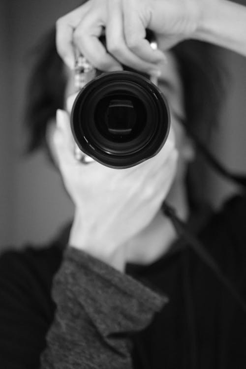 Woman Taking a Picture in Black and White 