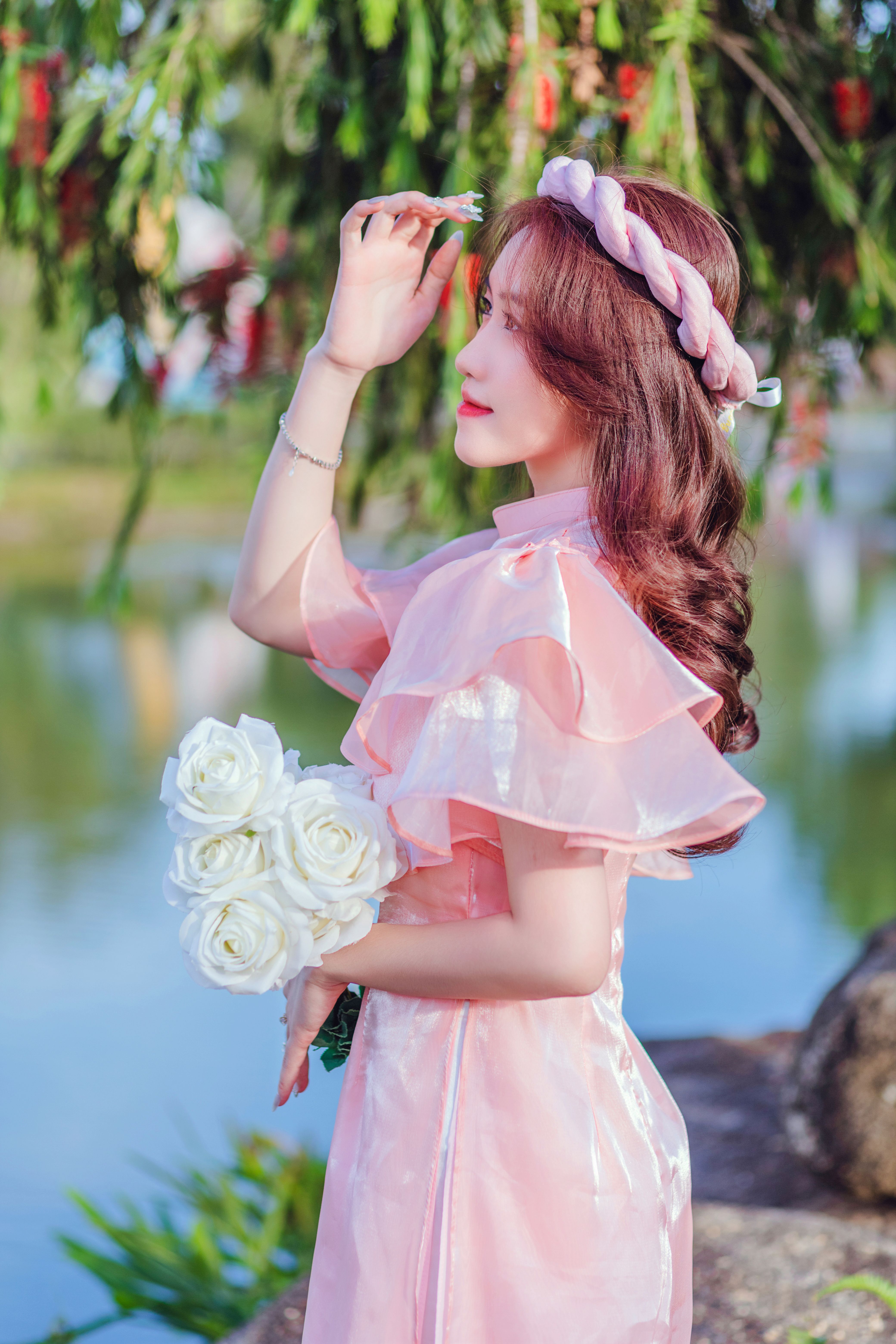 Woman in Pink Dress Holding Flowers · Free Stock Photo