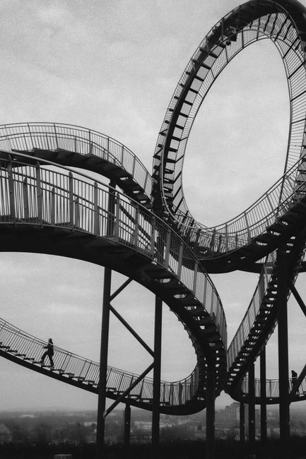 Black and white photo of the Tiger and Turtle walkway, a modern art landmark in Duisburg.