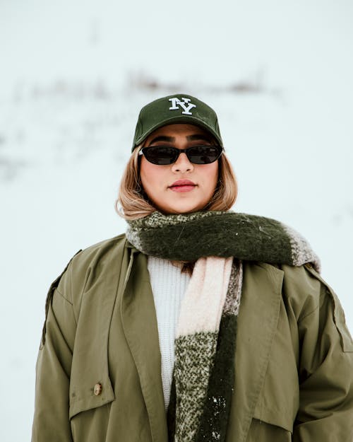 Young Woman in Warm Clothing and Sunglasses Standing Outside in Winter