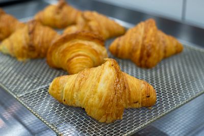 Golden croissants on a cooling rack by Arda Kaykisiz on Pexels