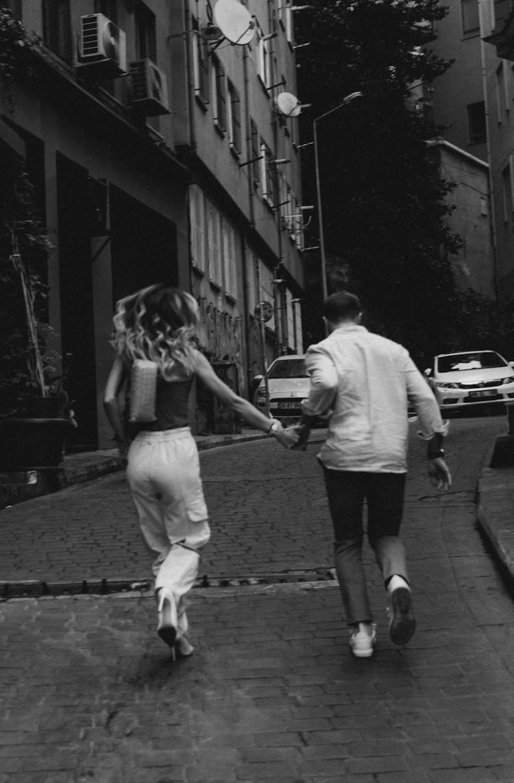 Couple Walking On A Street In Black And White 