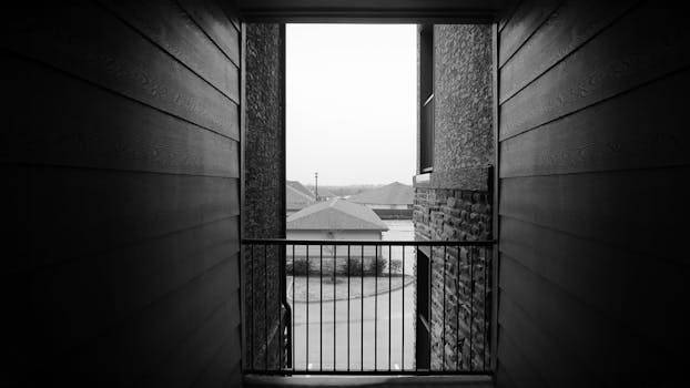 Monochrome view from the balcony overlooking a residential area.