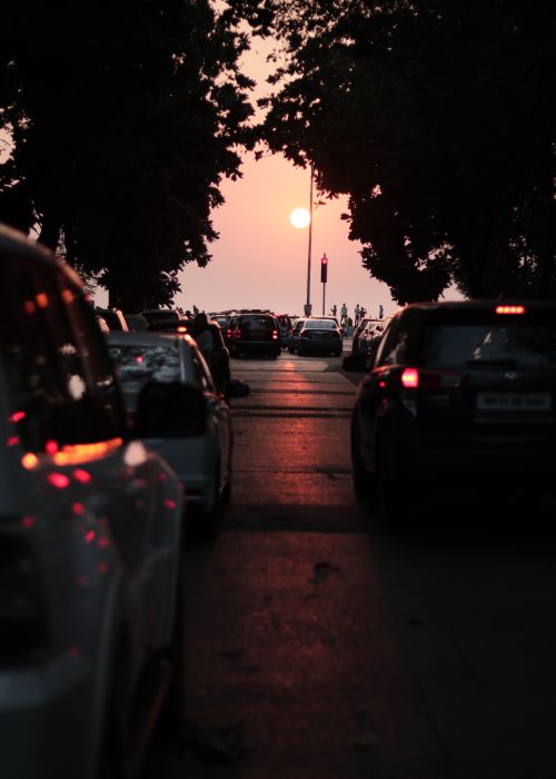 Free Busy Mumbai street at sunset with silhouette of cars and city skyline. Stock Photo
