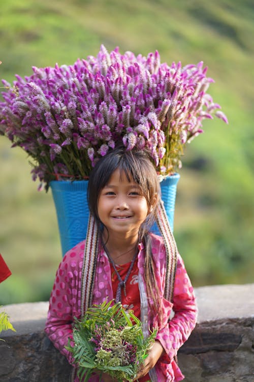 Little Girl in Front of Purple Tulips in a Basket 