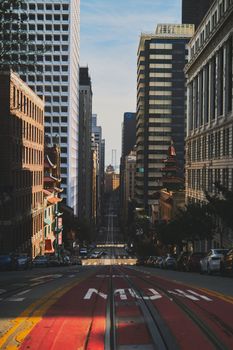 Dynamic view of a bustling city street lined with modern skyscrapers and urban architecture.
