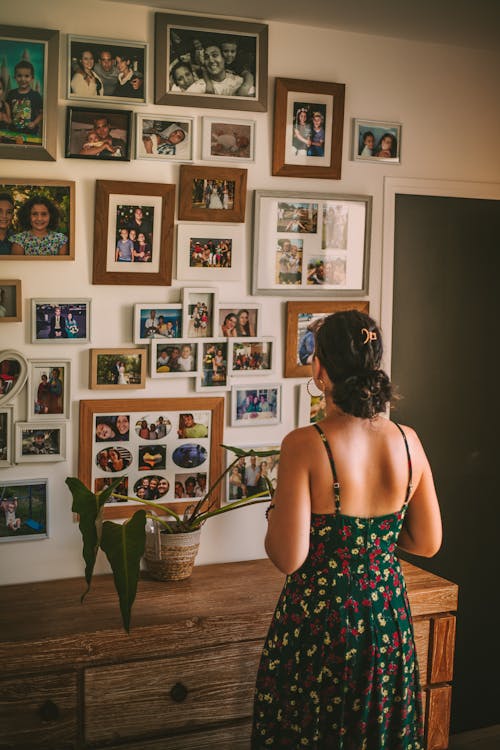 Woman Looking at Pictures in a Living Room 