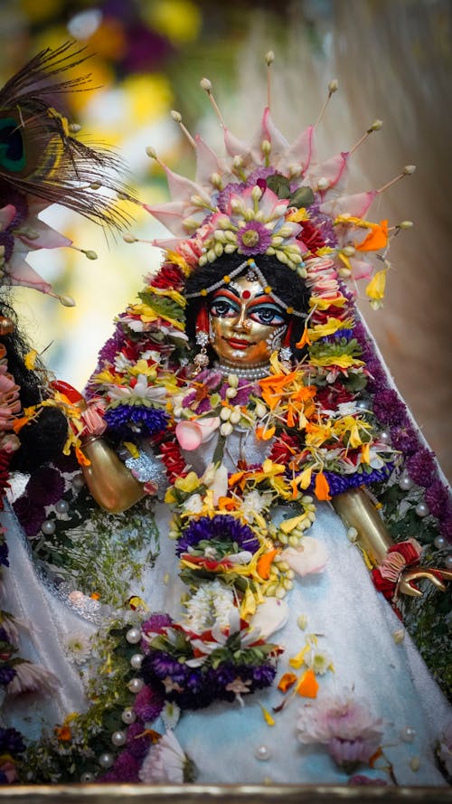 A statue of the goddess durga is decorated with flowers
