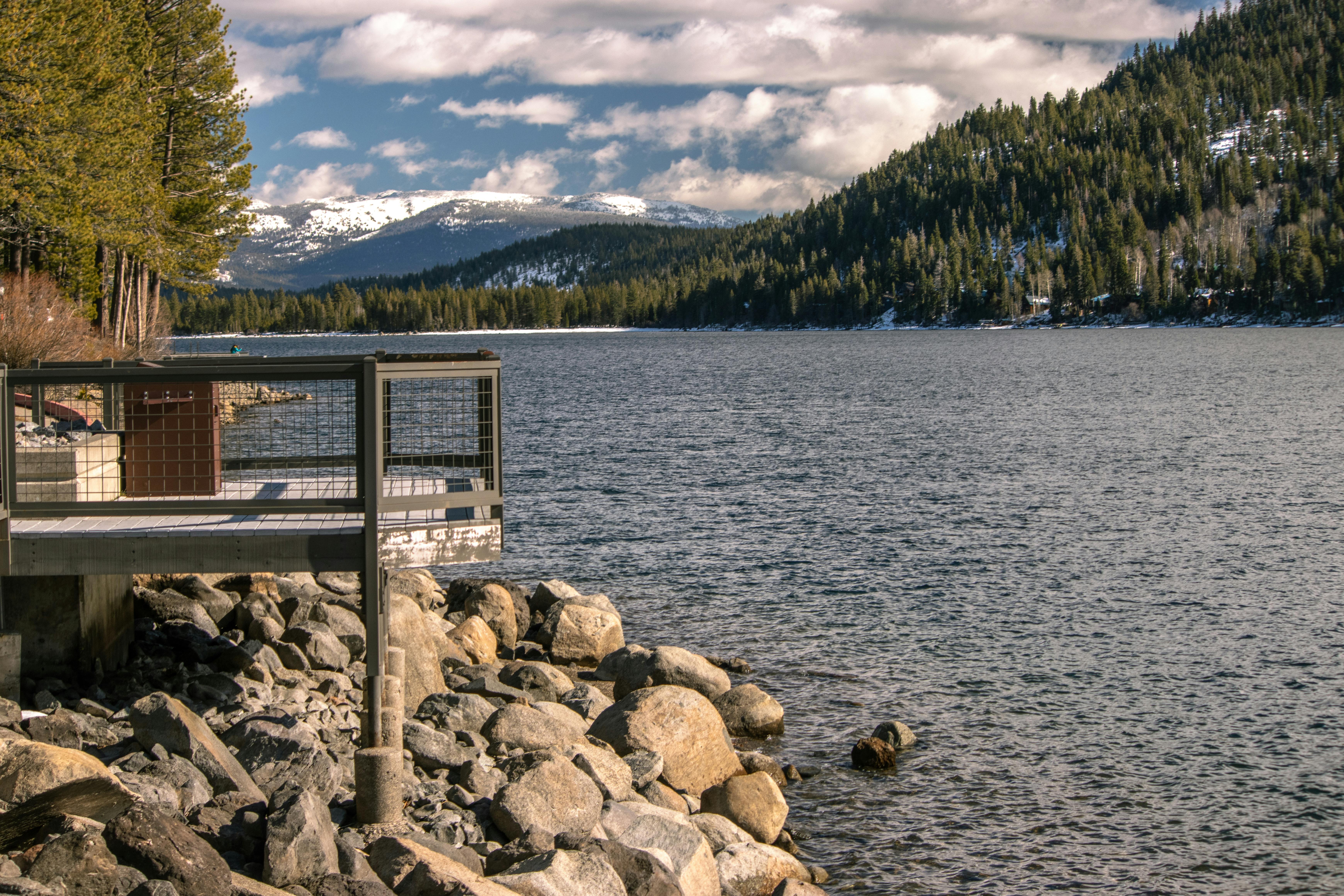 A beautiful winter scene of Donner Lake with snow-capped mountains and tranquil waters in Truckee, California.