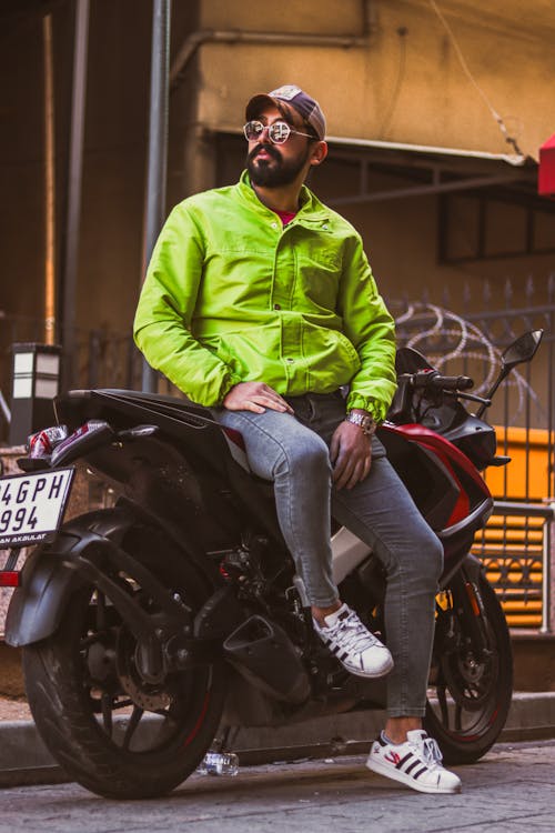 Man in Green Jacket Sitting on Motorbike