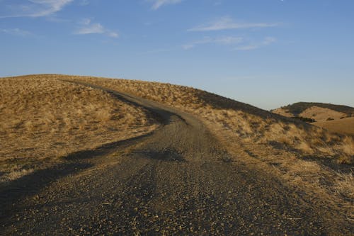 Dirt Road on Hill in Countryside
