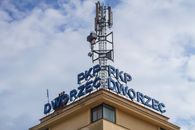 Close-up of PKP train station in Krynica-Zdrój with communication tower against the sky.