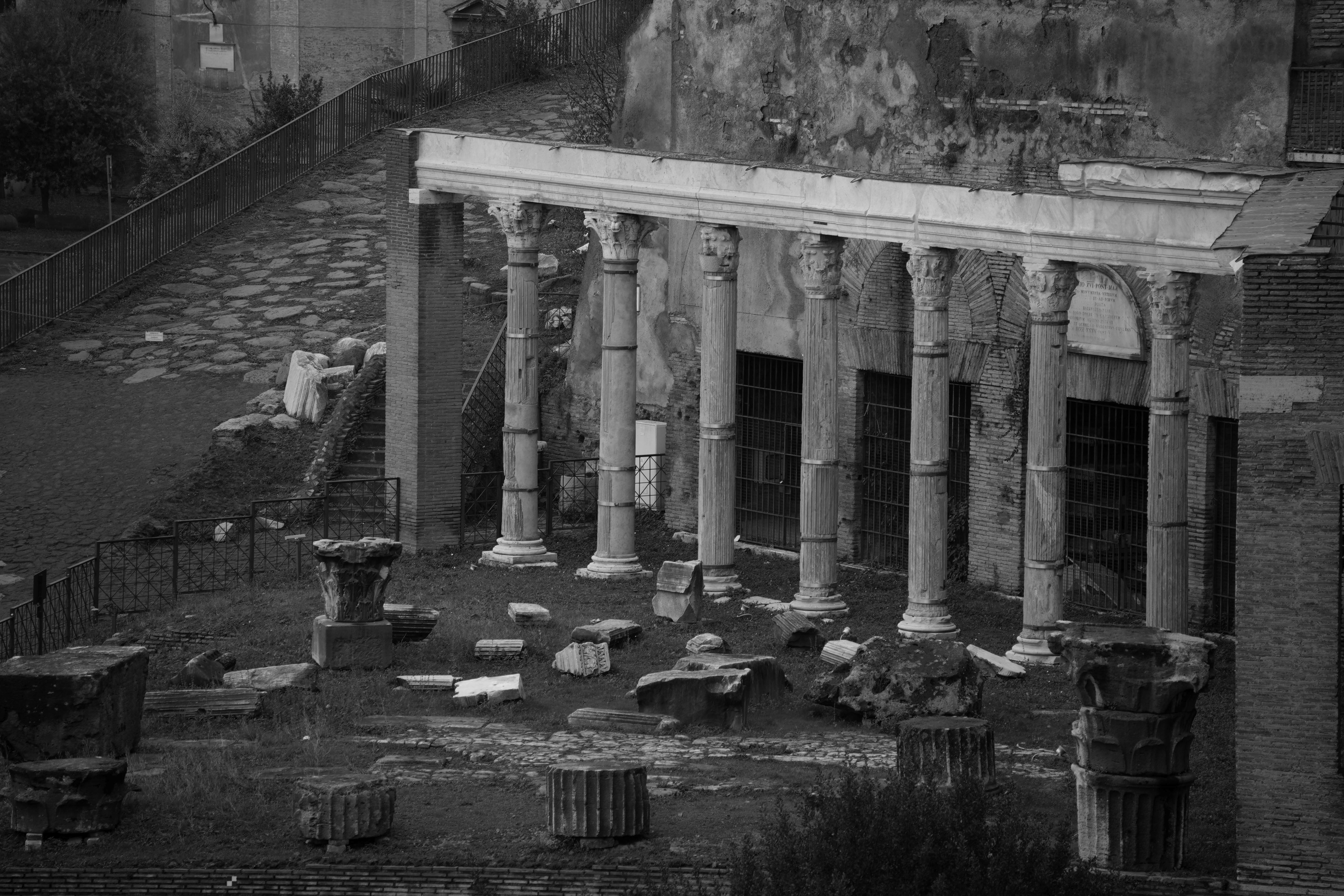 Black and white photo capturing ancient ruins in Rome's Forum Romanum.