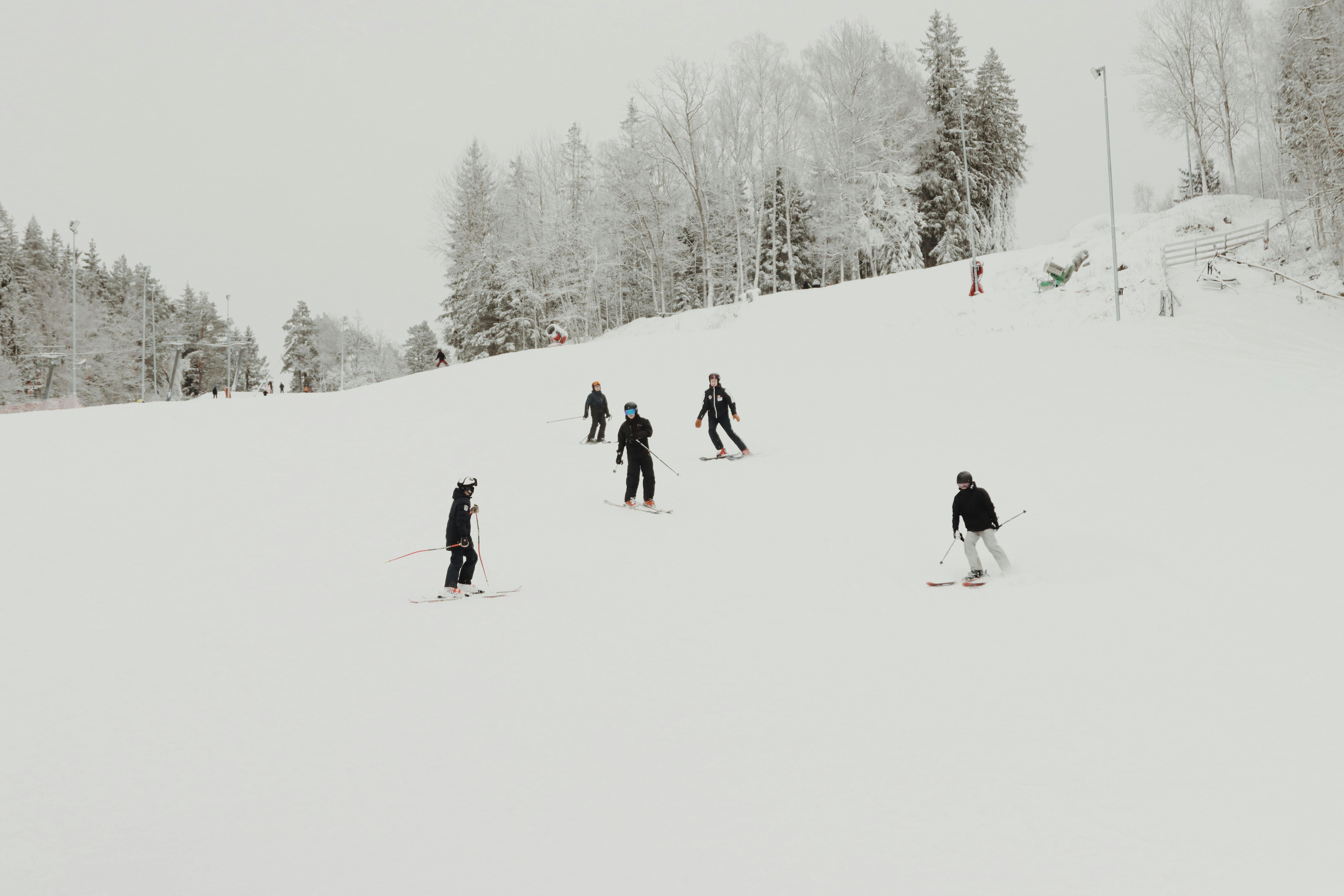 Group of skiers enjoying winter sport on snowy slope in Jönköping, Sweden.
