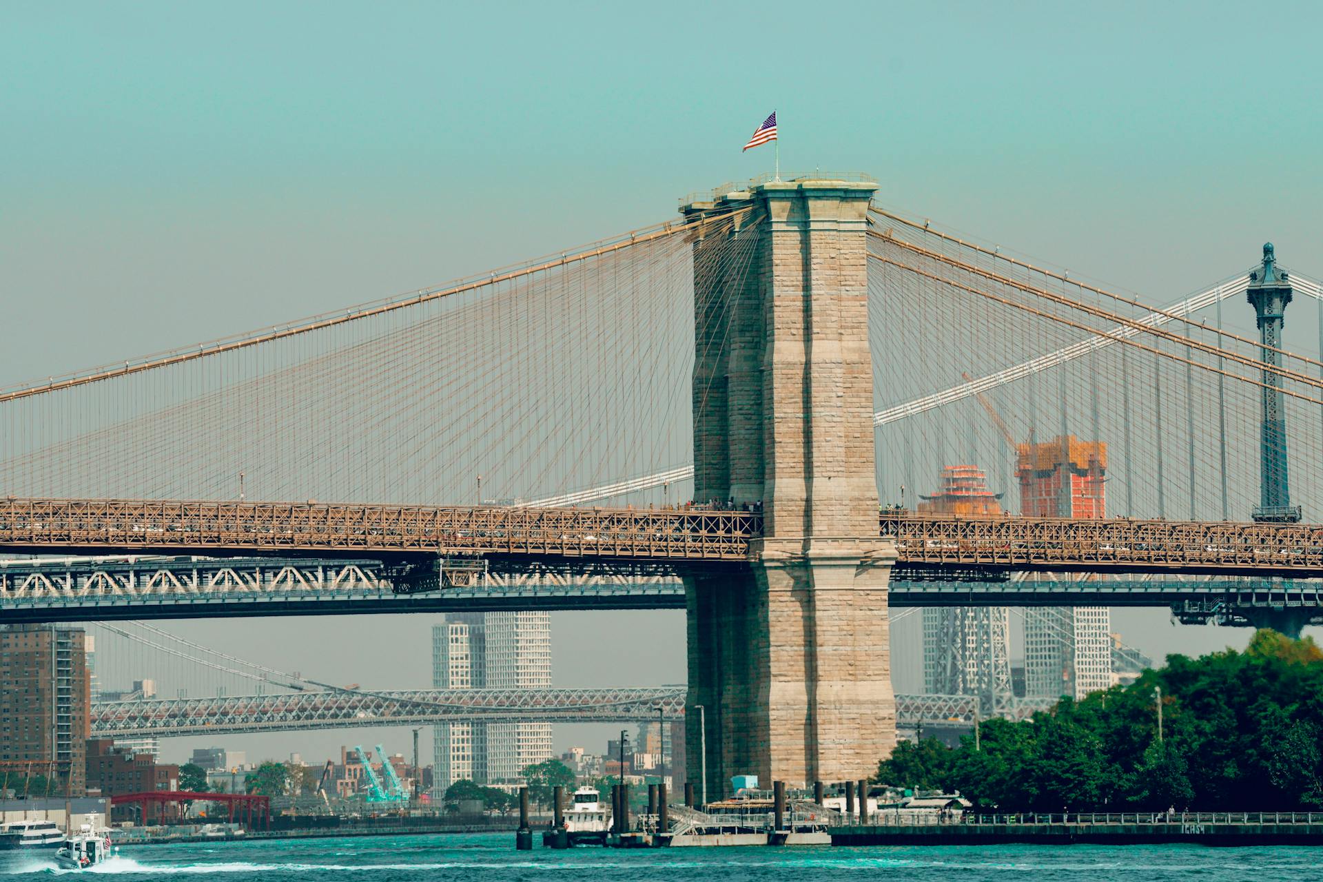 Scenic view of the iconic Brooklyn Bridge with New York City skyline in the background.