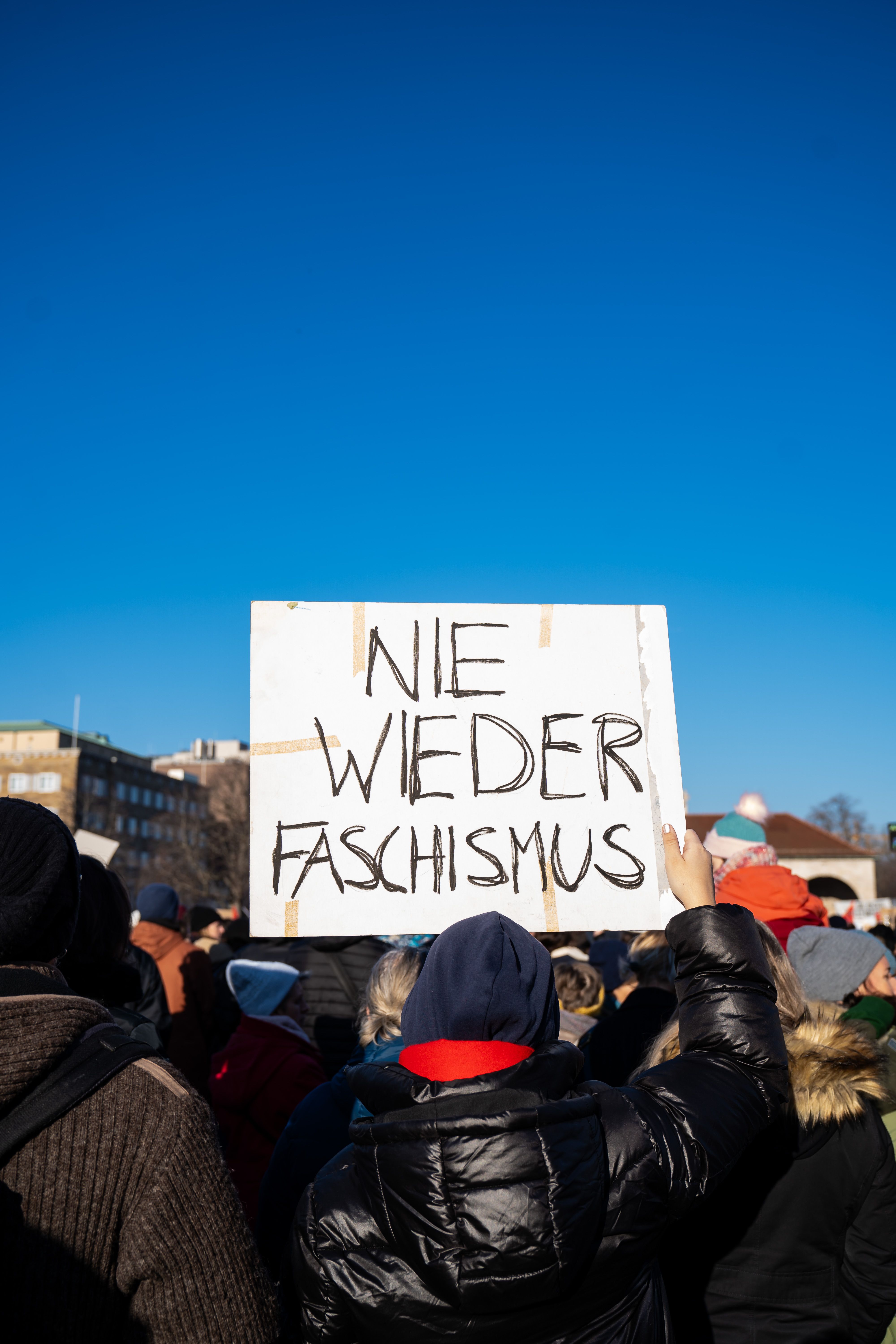 Demonstration against fascism in Stuttgart, Germany with protester holding a sign.