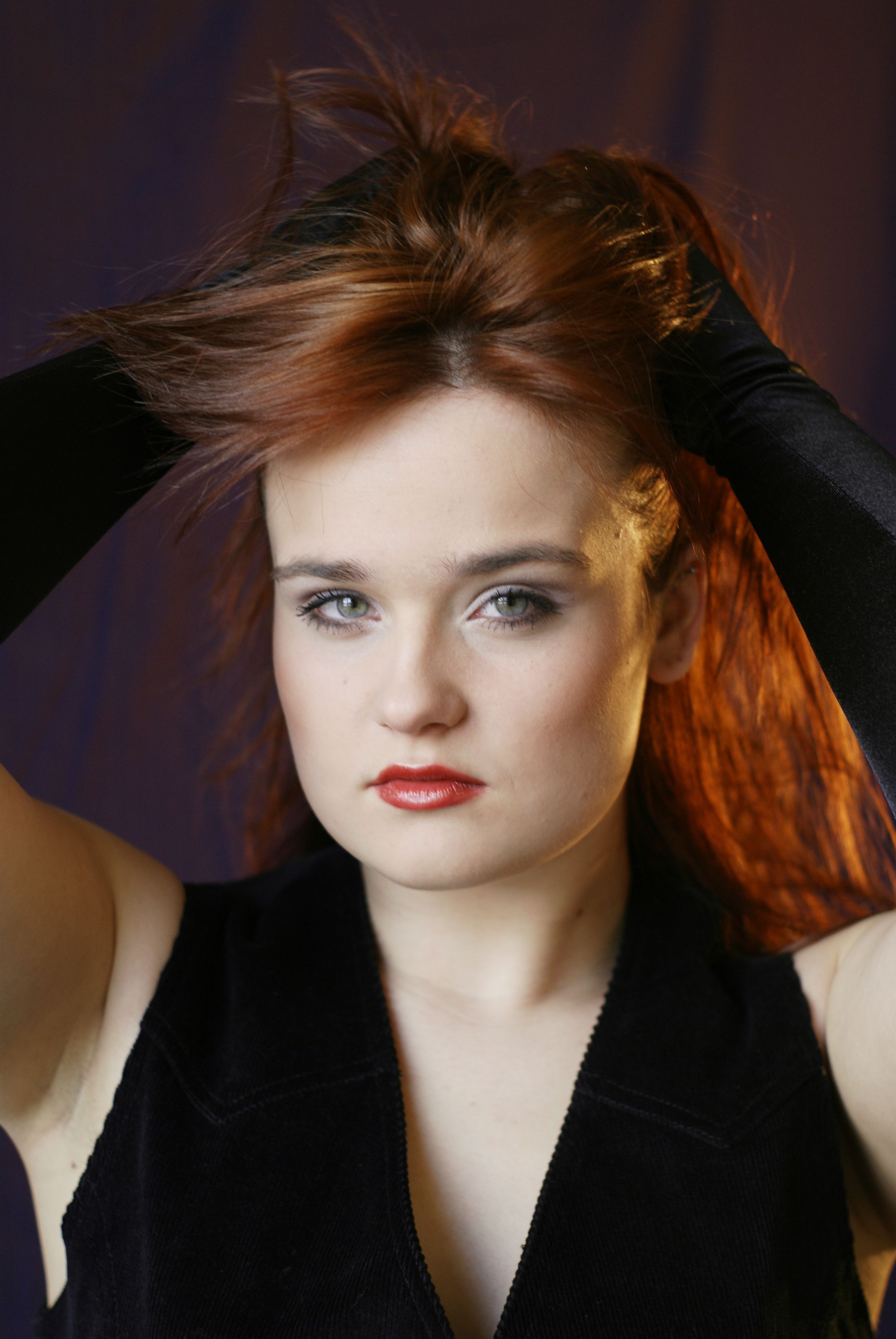 A woman with red hair and black gloves · Free Stock Photo