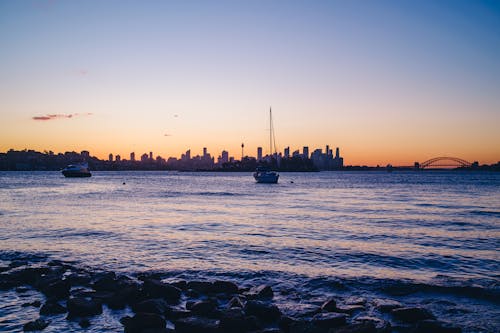 Sailboats and Cityscape at Dusk