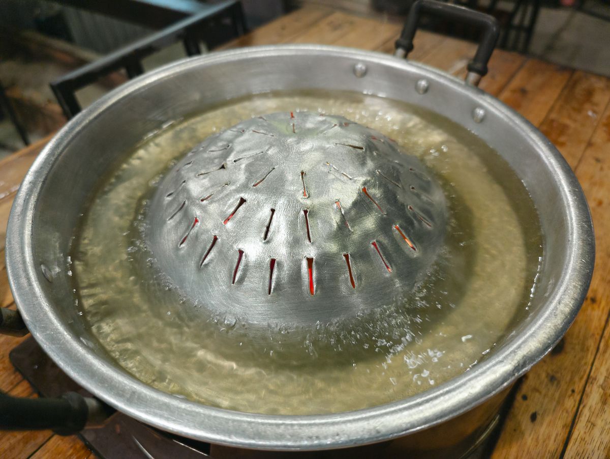 Steam rising from a pot of boiling water, illustrating the evaporation stage of water distillation