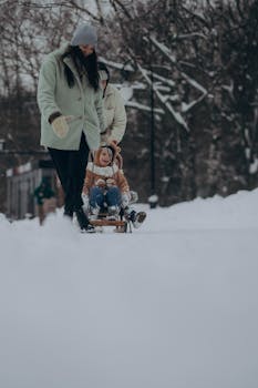 A family sledding through a snowy park, evoking joy and winter fun.