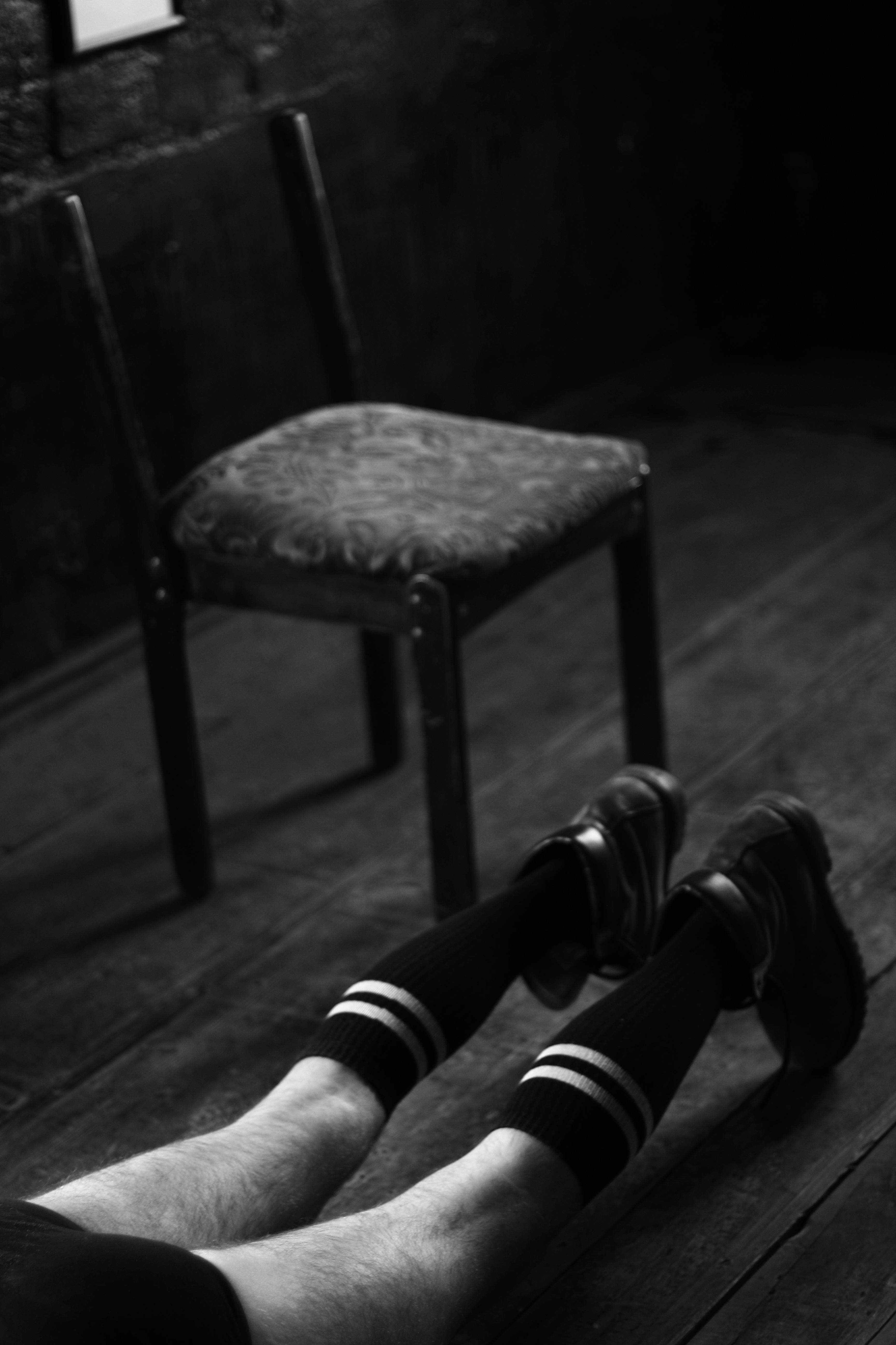 man lying on a floor in black and white