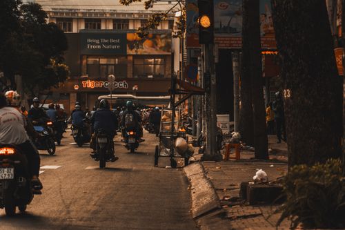 Free A bustling city street filled with motorbikes during daytime traffic. Stock Photo