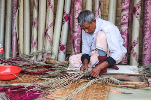  Man Weaving Mats