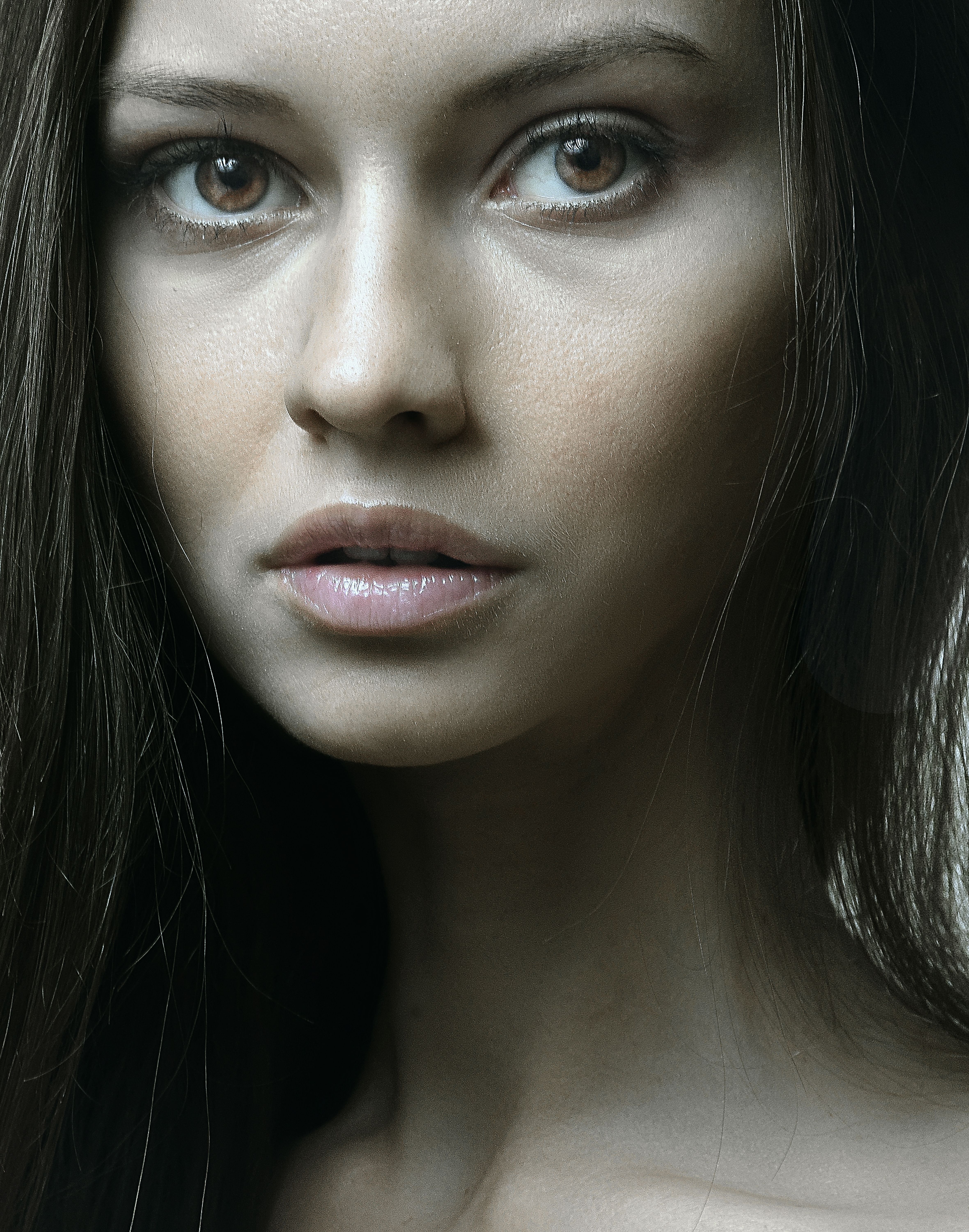 Close-up portrait of a woman with long dark hair and captivating eyes.