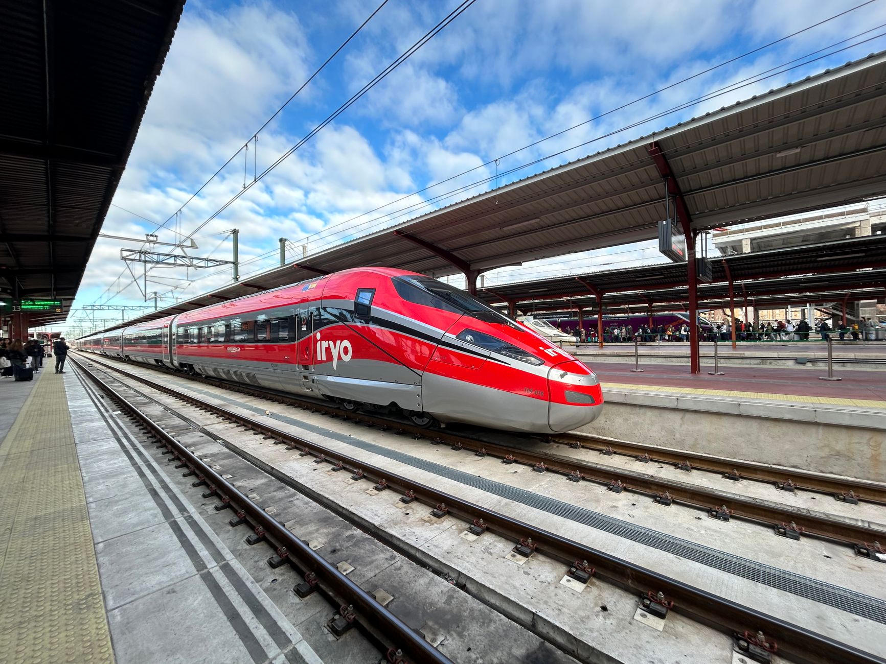 Best Train Between Madrid and Barcelona 7 Iryo high-speed train at Madrid train station on a clear day, showcasing modern transportation.
