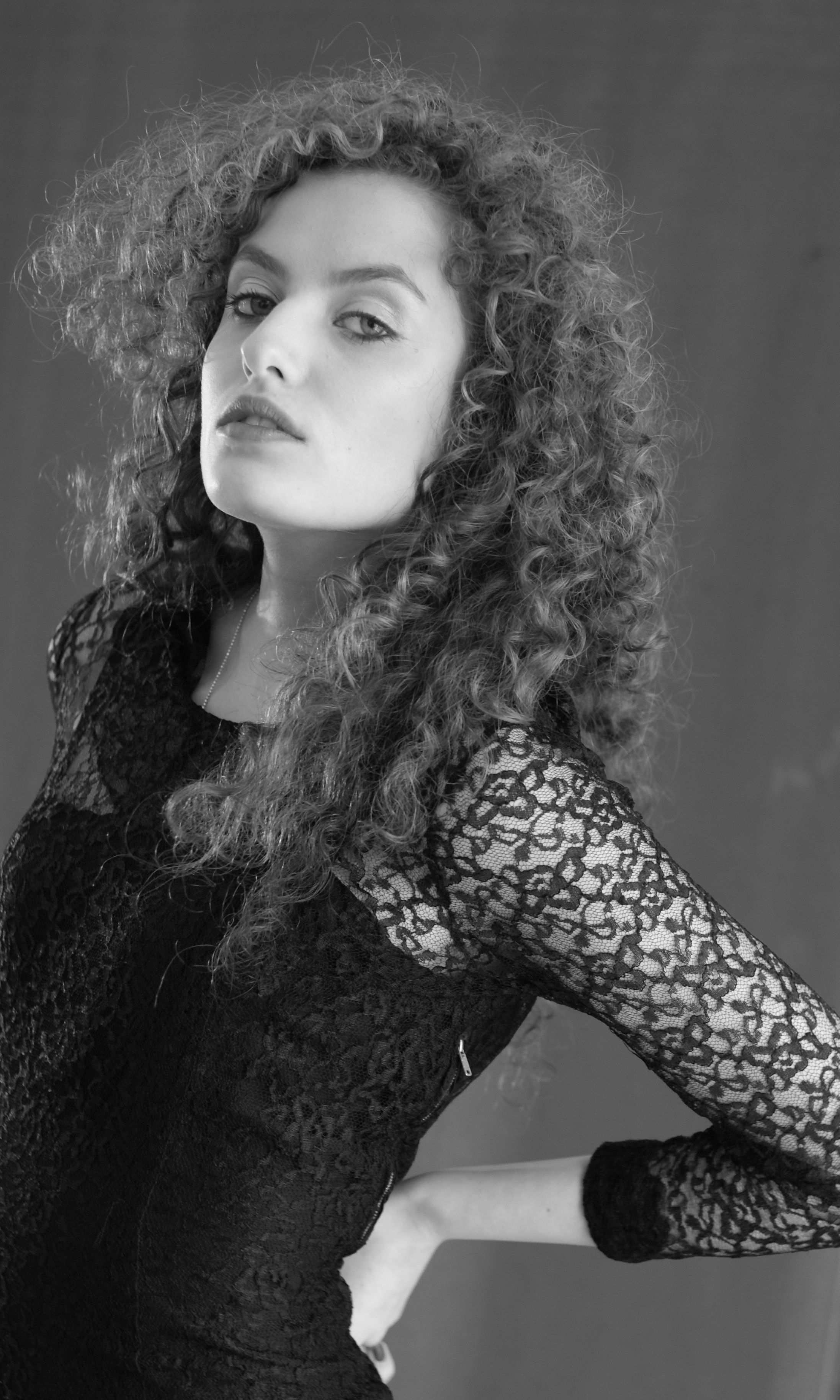 A woman with curly hair posing for a black and white photo · Free Stock ...