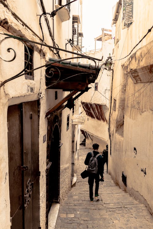 Tourist in Narrow Alley in Ancient City