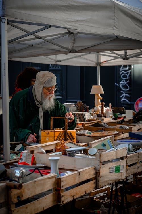 A man is selling items at a flea market