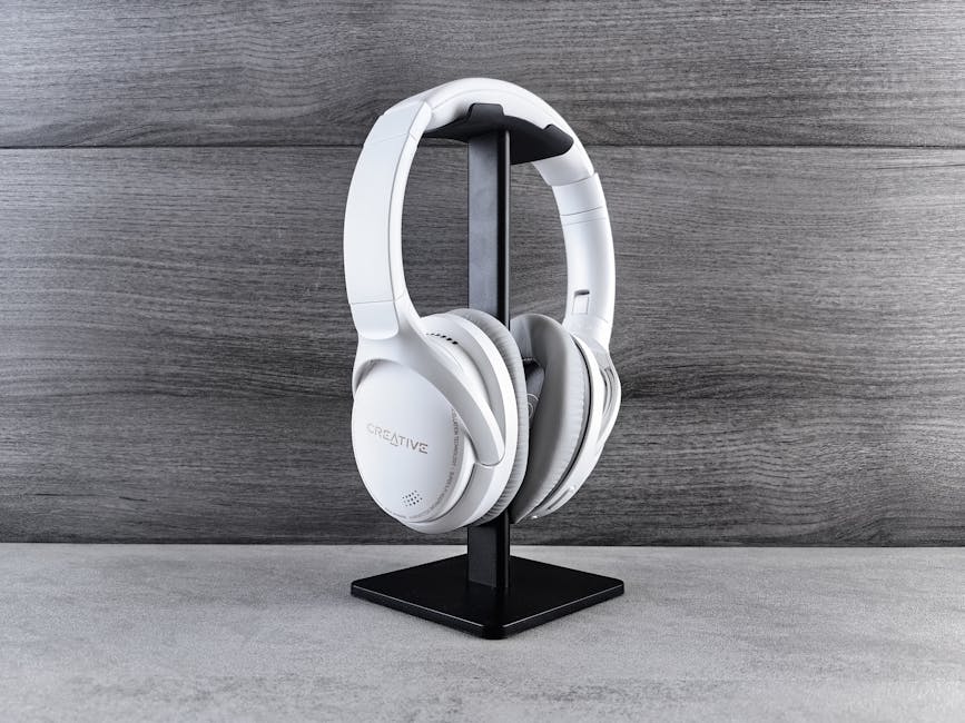 Does Robinhood Beat Fidelity or Schwab for Beginners? White headphones on a stand against a wooden background, showcasing modern audio equipment.