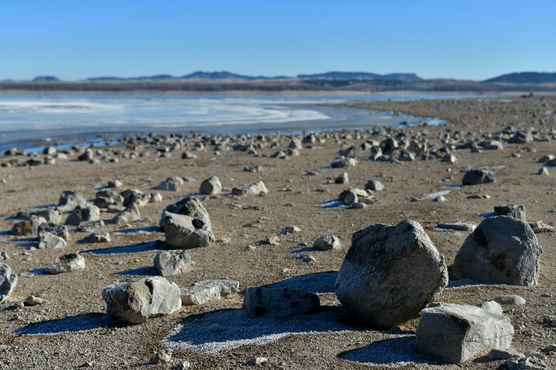 A serene rocky shoreline of Glendo Reservoir, Wyoming, captured during winter.