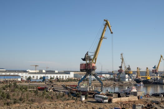 View of industrial cranes and harbor area at Baku, Azerbaijan during a clear day.