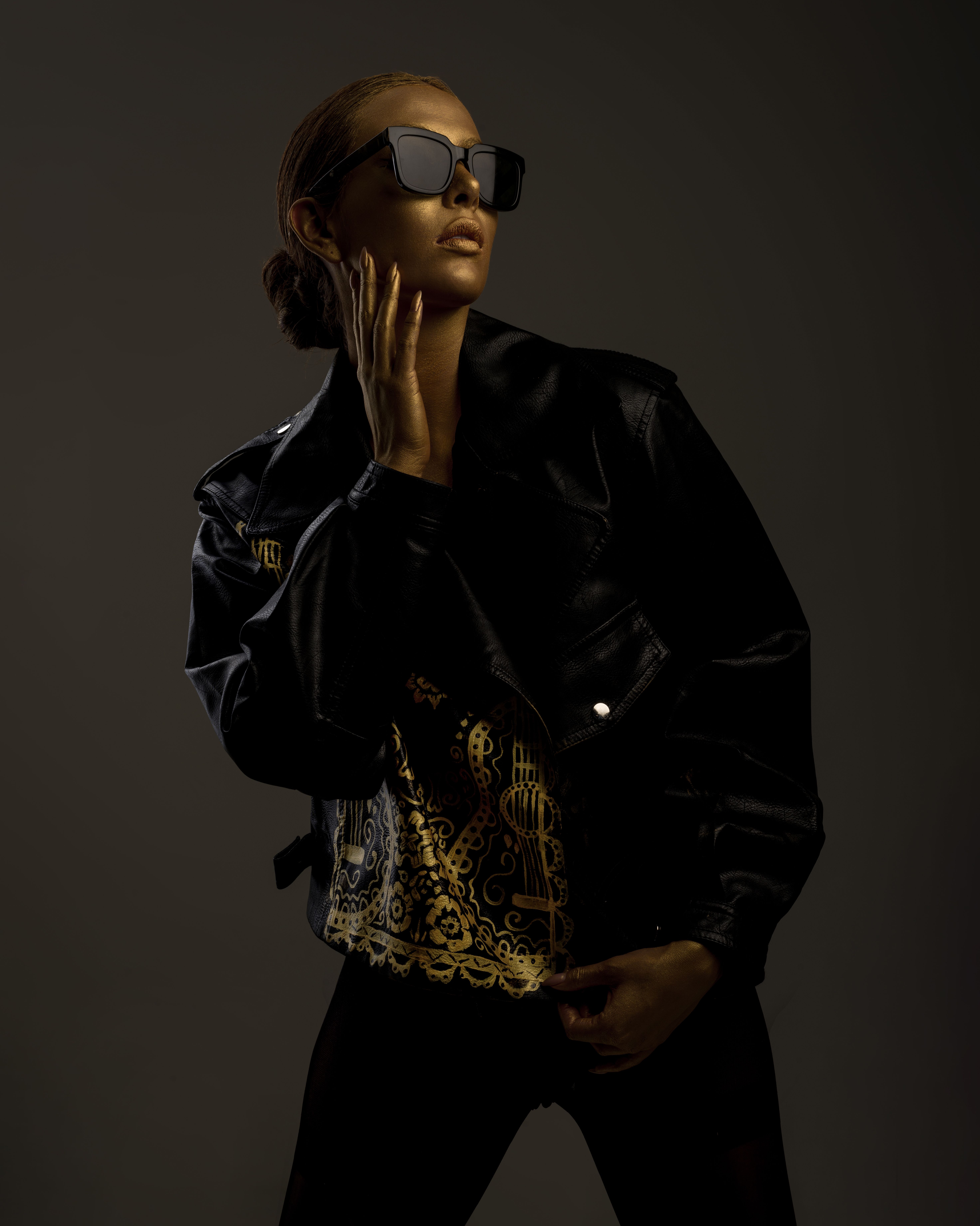 Woman styling a black leather jacket