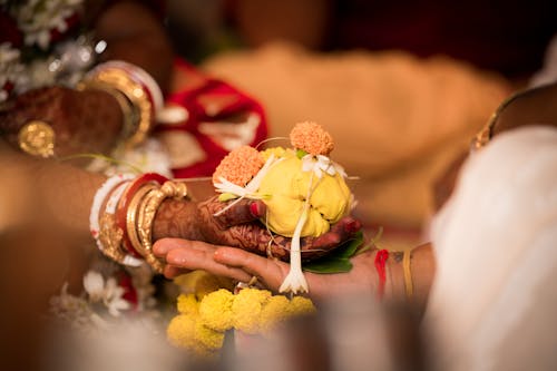 Man and Woman in Traditional Jewelry Holding Hands