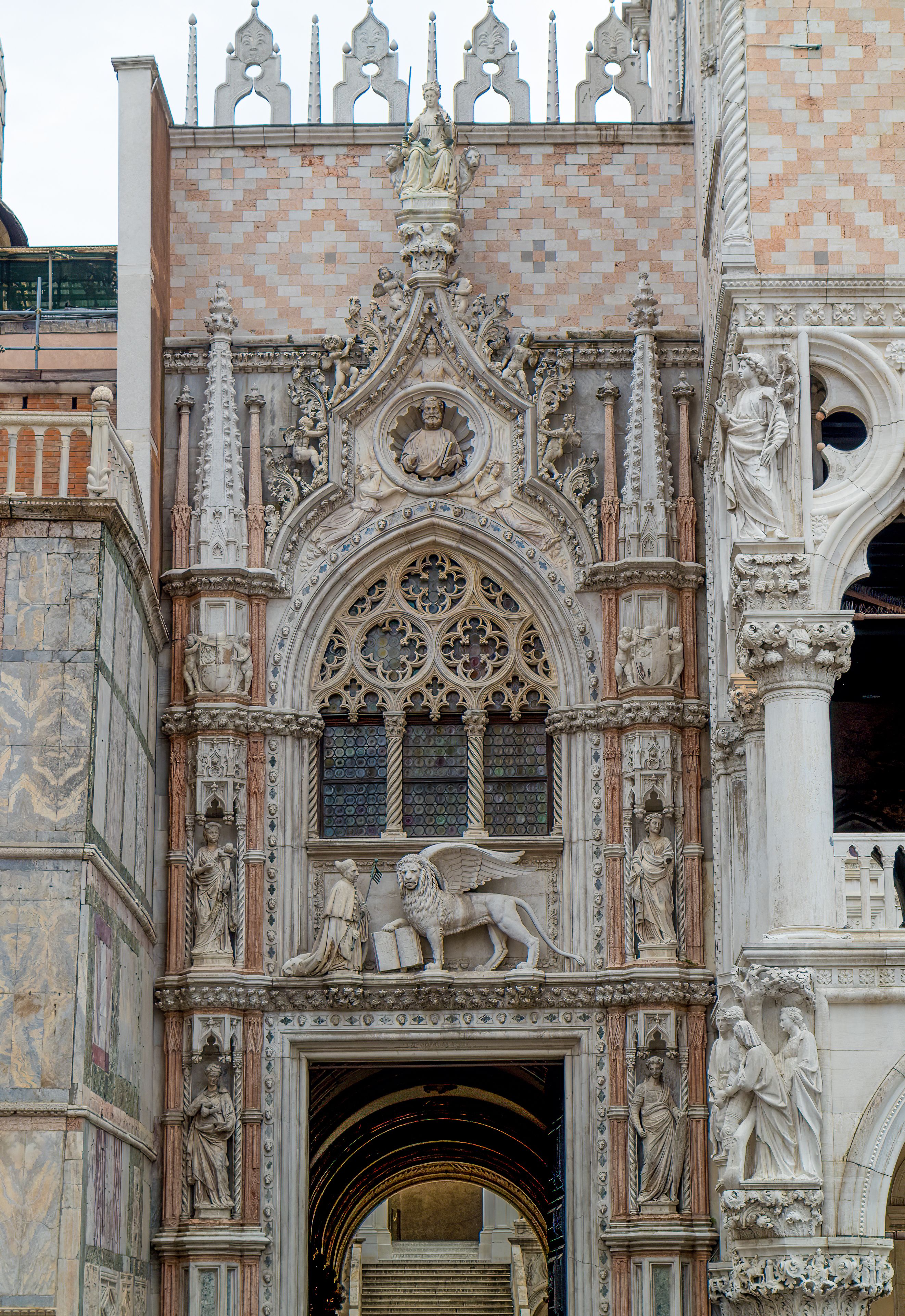 Intricately carved Gothic archway at St Mark's Basilica in Venice, showcasing historic architecture.